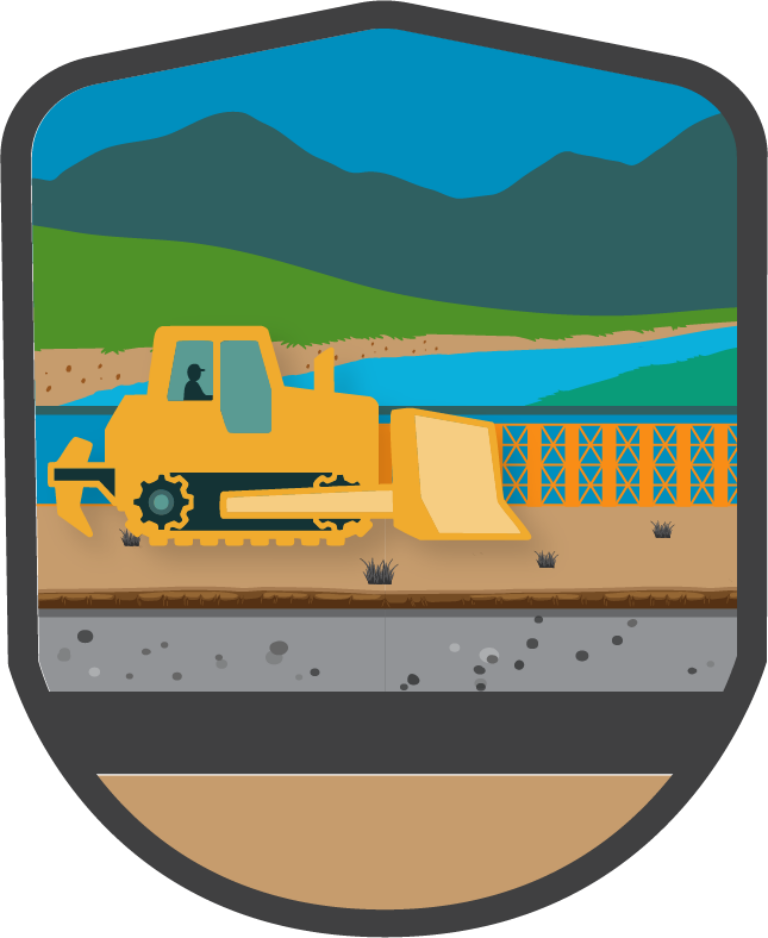 Yellow bulldozer with driver on a riverside construction site with mountains and water in the background
